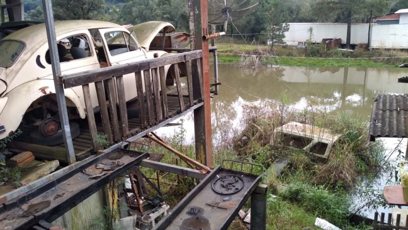 Carcaça de fusca e pedaços de outros veículos eram mantidos ao lado de açude em estabelecimento interditado pela 83ª fase da Operação Desmanche, em Caxias do Sul.