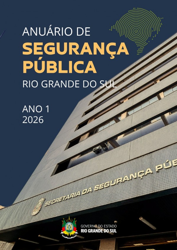 A imagem apresenta a capa do “Anuário de Segurança Pública Rio Grande do Sul – Ano 1, 2026”. O layout combina um fundo em azul-escuro com uma fotografia em perspectiva ascendente de um edifício institucional, destacando a imponência da construção e sua fachada revestida por pequenos azulejos claros. Na parte frontal do prédio é possível ler a inscrição “Secretaria da Segurança Pública”, enquanto na base da capa aparece o brasão e a identificação do Governo do Estado do Rio Grande do Sul. À esquerda, em destaque, estão os textos “ANUÁRIO DE SEGURANÇA PÚBLICA”, em letras grandes nas cores branca e dourada, seguidos da indicação “RIO GRANDE DO SUL” e “ANO 1 2026”. Na parte superior direita há um elemento gráfico formado por pontos verdes que remete ao contorno do estado do Rio Grande do Sul. A composição utiliza linhas diagonais e um enquadramento de baixo para cima, transmitindo uma ideia de institucionalidade, modernidade e solidez associada à gestão da segurança pública.